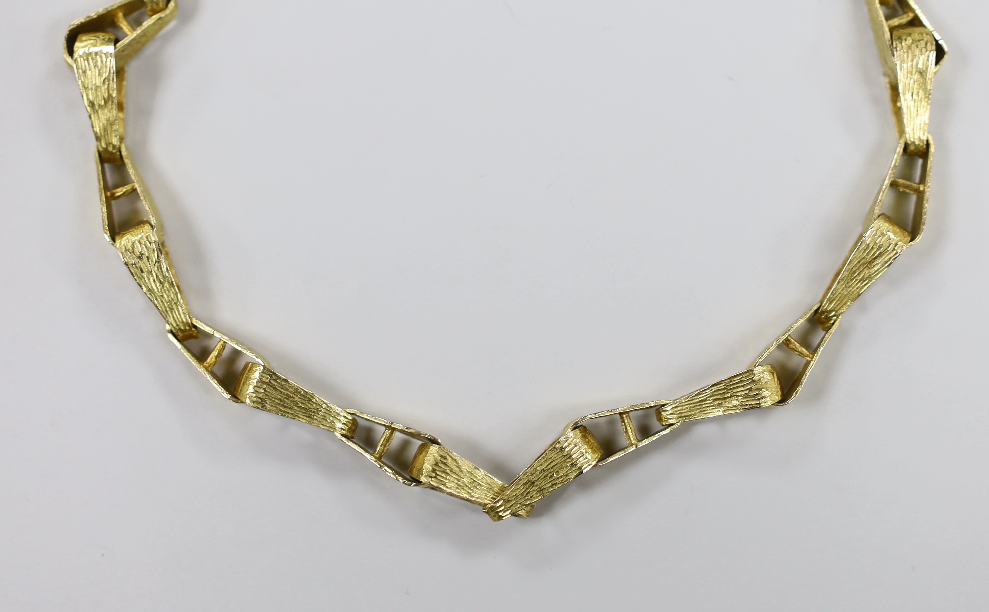 A 1970's textured 9ct gold tapered link necklace, 76cm, 57 grams.